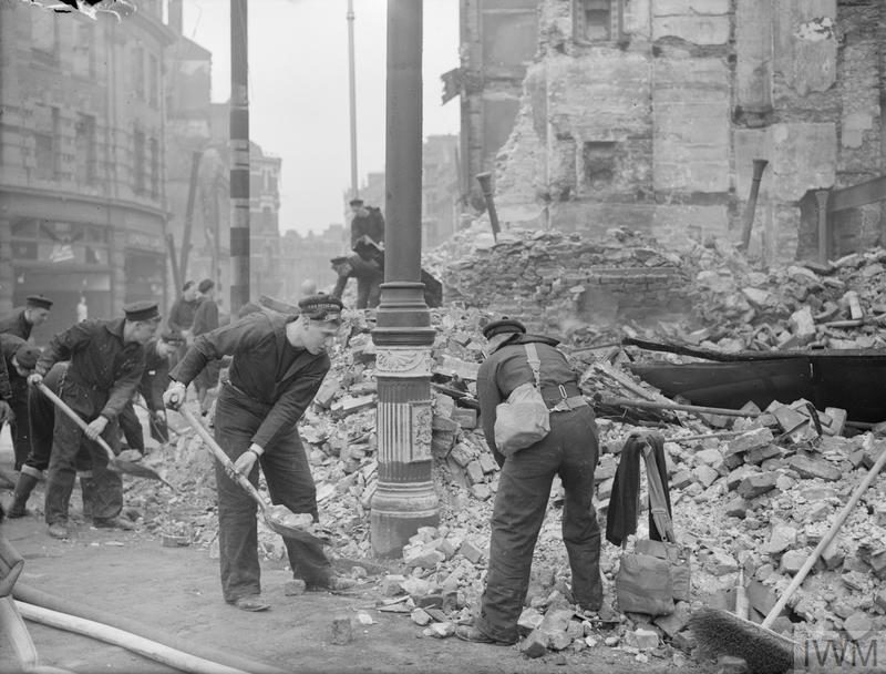 Norwegian sailors help to clear up after Plymouth Blitz of 21 March 1941. Copyright: © IWM