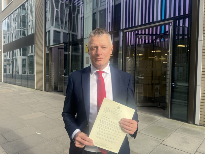 Luke with his dentistry letter outside the Department of Health and Social Care